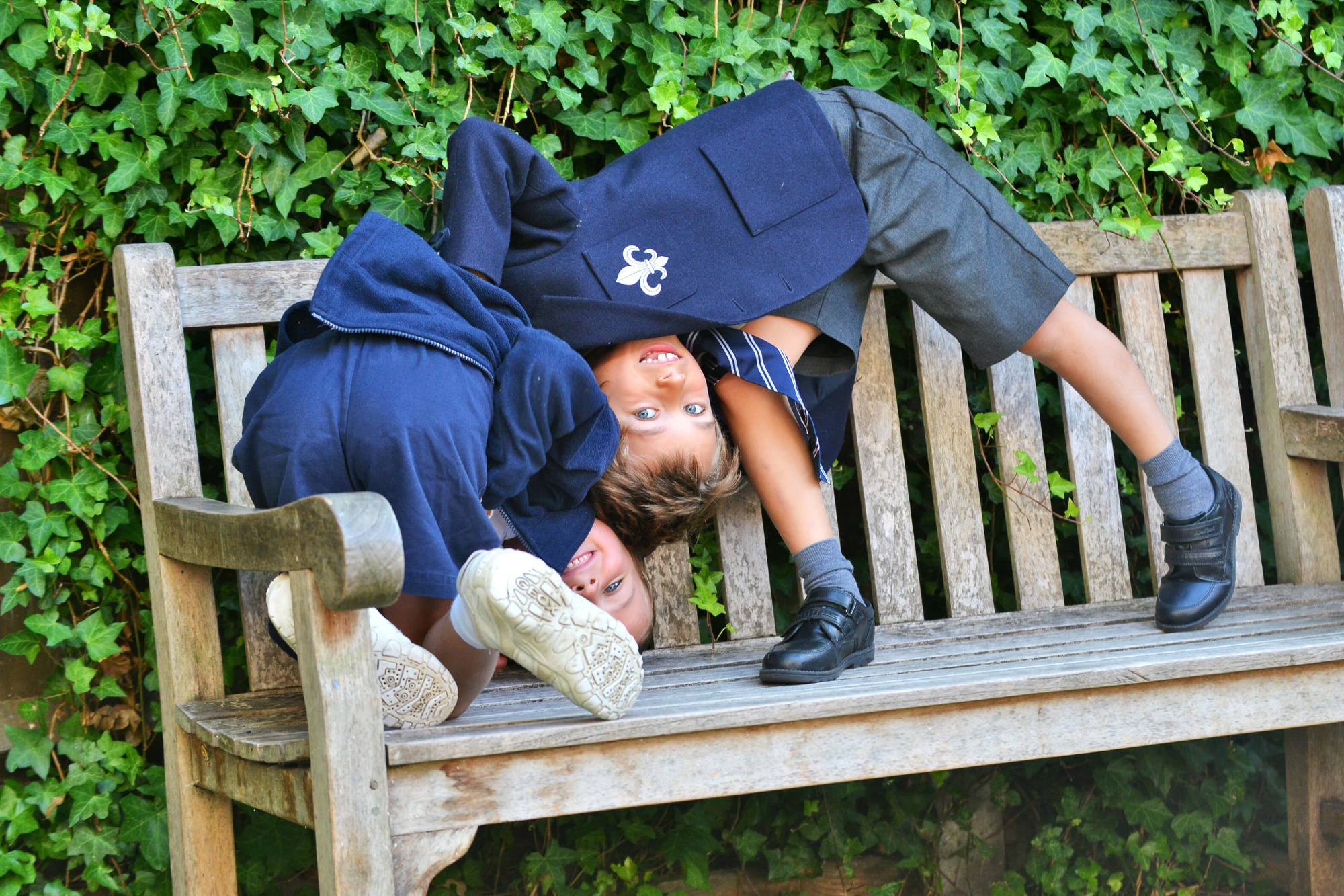 Two Hereward House boys playing on a bench in the school garden